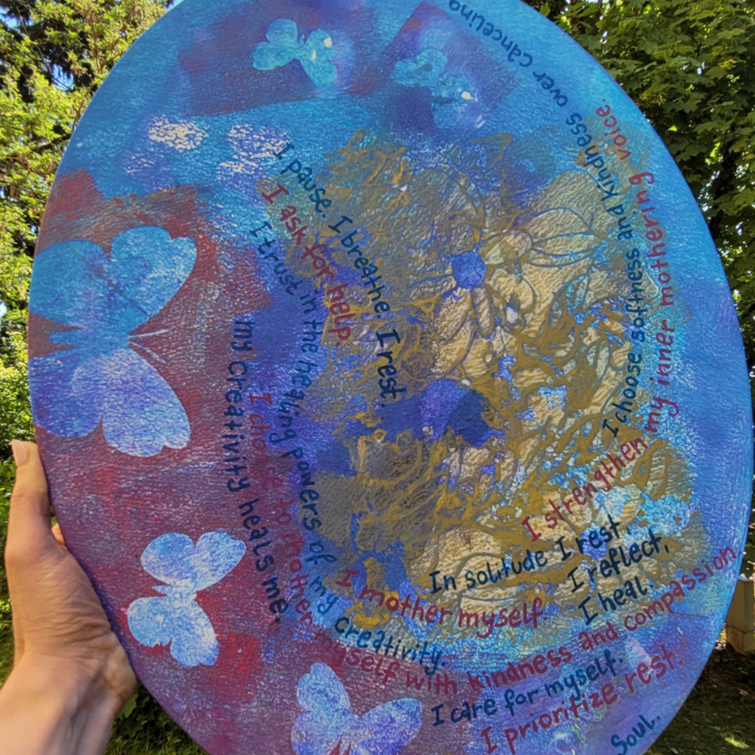 Painting of affirmations spiralling around an oval canvas, held outdoors in a garden — Daniela's own love notes to herself.
