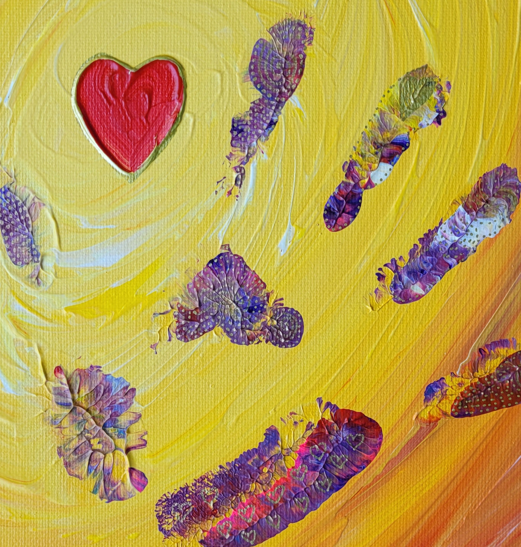 A painted red heart on warm yellow swirl, with a purple-pink handprint at the centre.